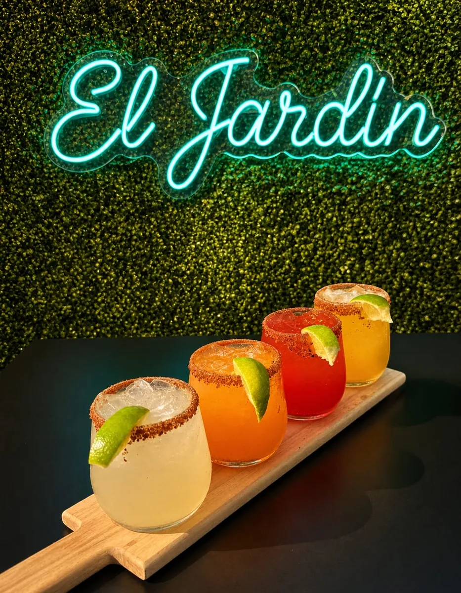 The Margarita Flight — four chile-rimmed margaritas under the El Jardín neon