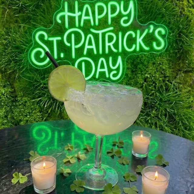 A margarita under the Happy St. Patrick's Day neon sign