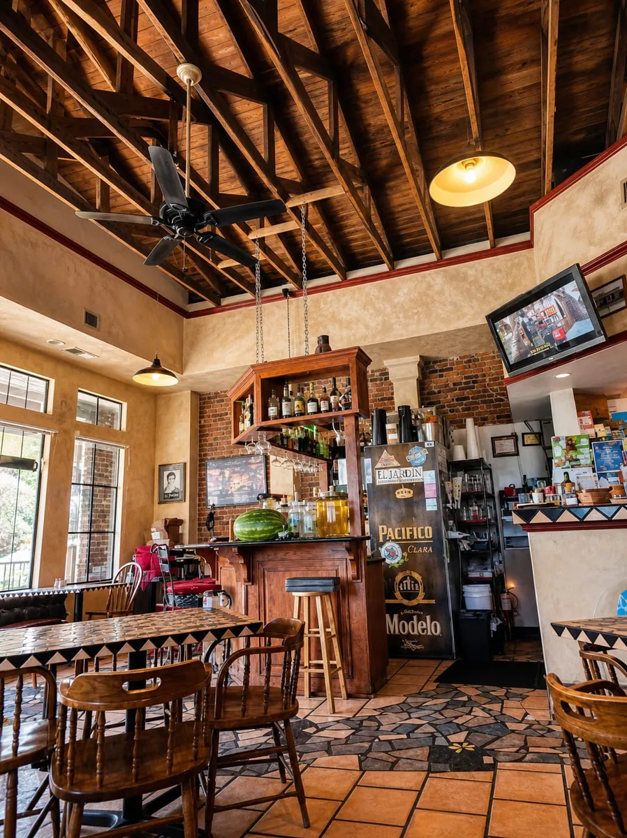 The little bar under the wood-truss ceiling, stocked and glowing